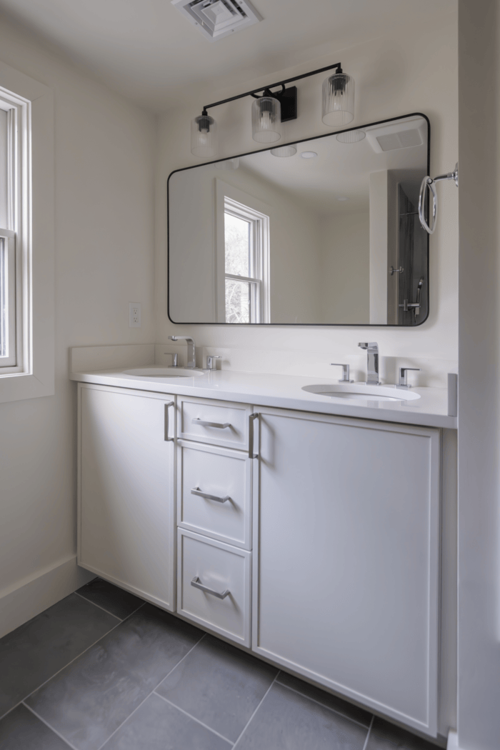 White double vanity with quartz countertop and black framed mirror in Lexington MA White double vanity with quartz countertop and black framed mirror in Lexington MA