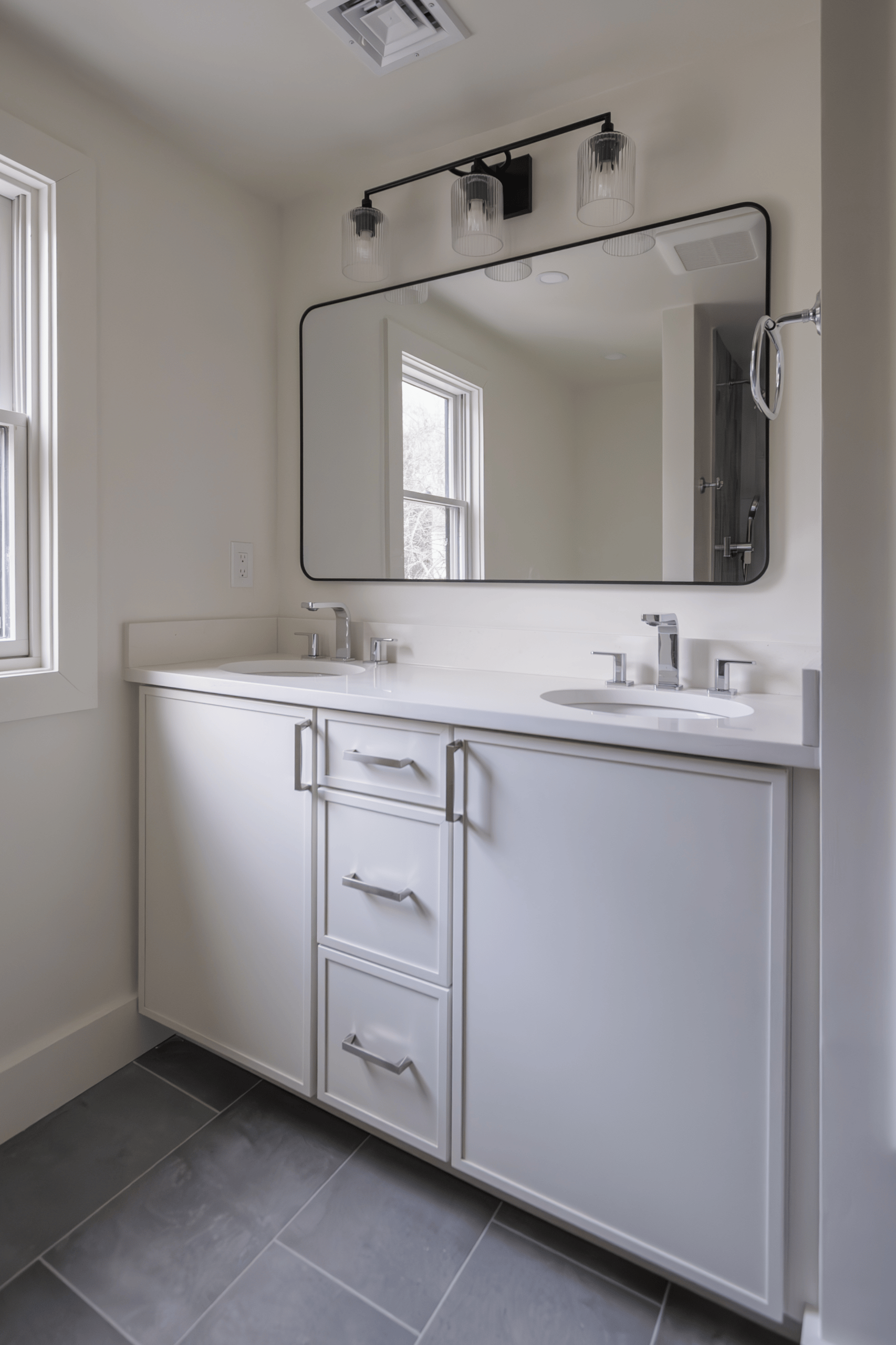White double vanity with quartz countertop and black framed mirror in Lexington MA