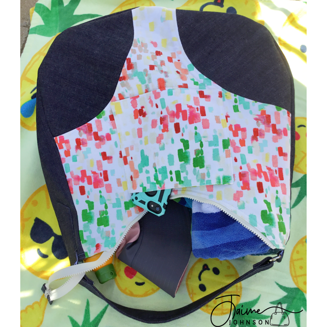 Summer Beach Bag Laying open with towel, hat and phone tumbling out