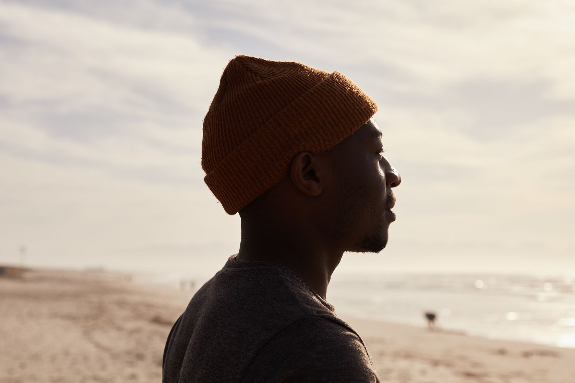 black man standing on beach