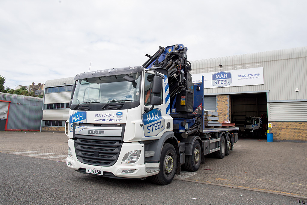 A MAH Steel HIAB crane lorry loaded with steel parked outside the MAH Steel workshop in Gravesend