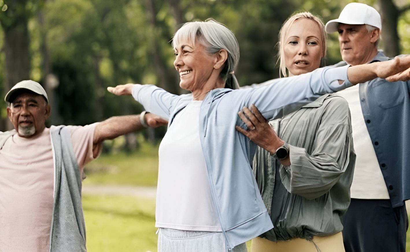 Fitness instructor helping senior citizens to exercise and help with fall prevention.