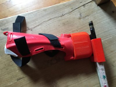 3D printed prosthetic bow holder with bow and velcro for attaching to the arm.
