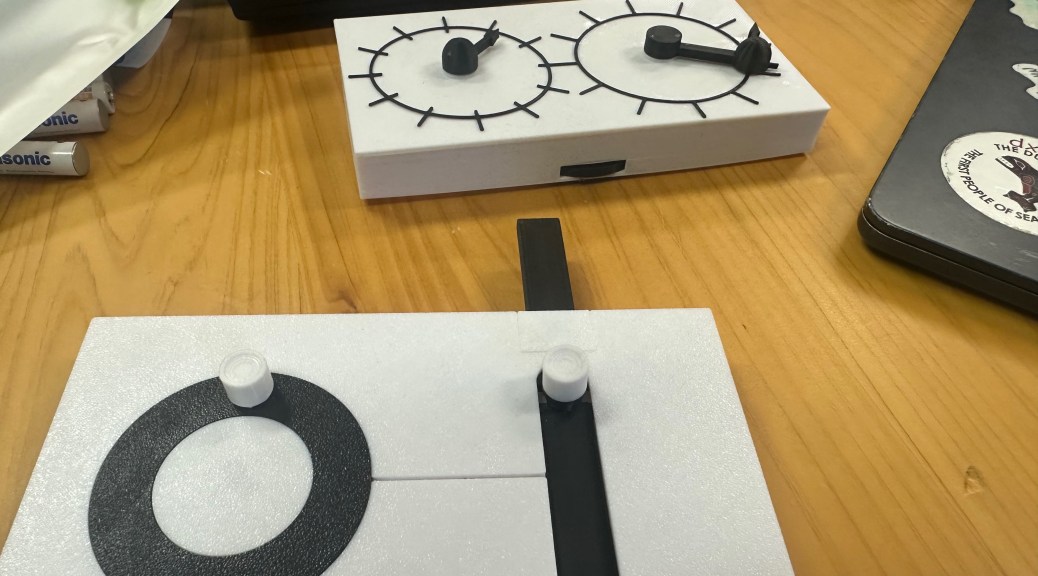 two 3d printed devices for teaching about physics. Both have moving parts that connect concepts such as angular velocity and momentum in a tactile farmat.