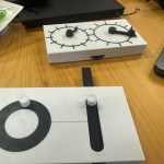 two 3d printed devices for teaching about physics. Both have moving parts that connect concepts such as angular velocity and momentum in a tactile farmat.