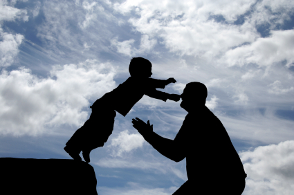 Boy jumping to land safely in fathers arms