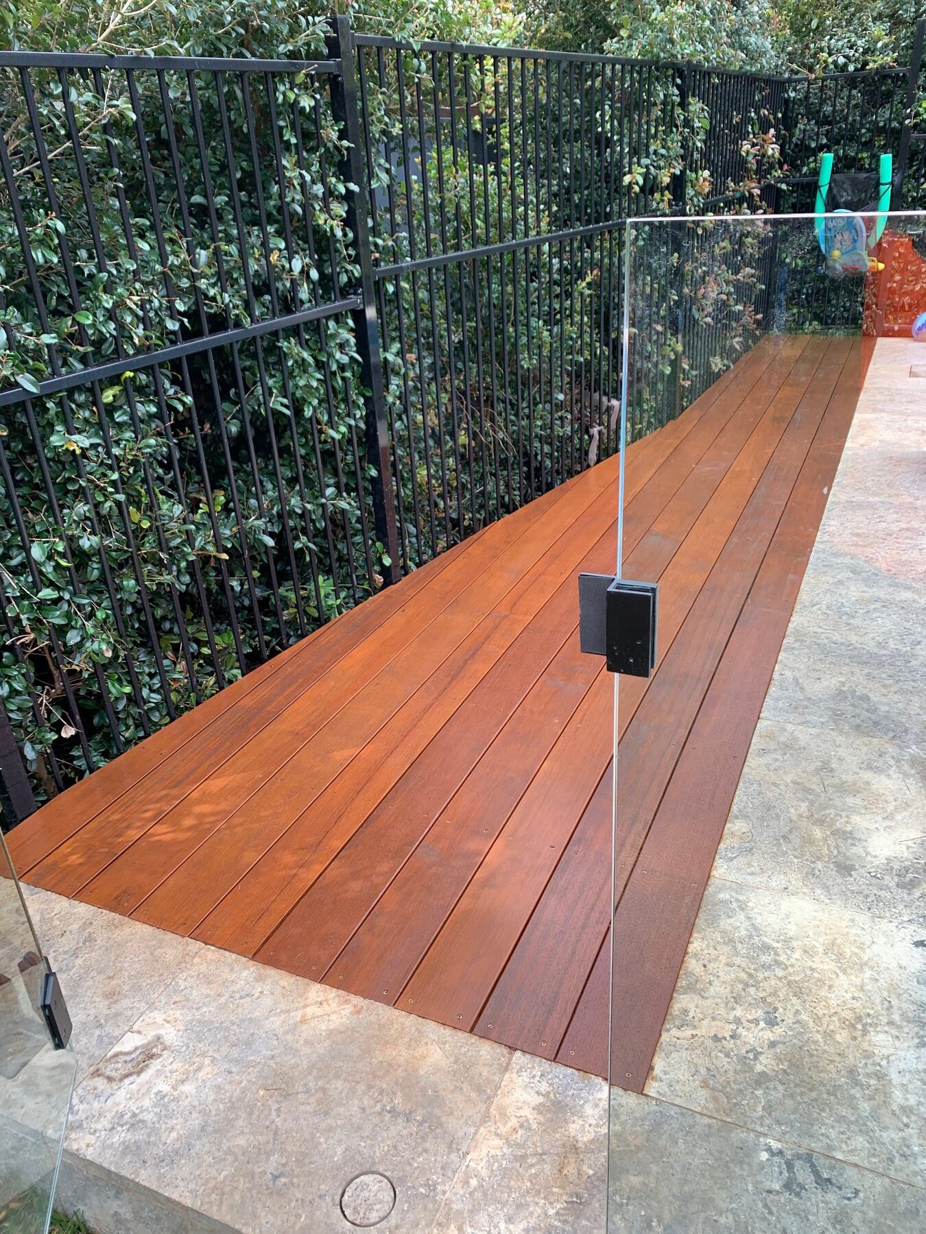 Completed elevated Merbau walkway with glass balustrade