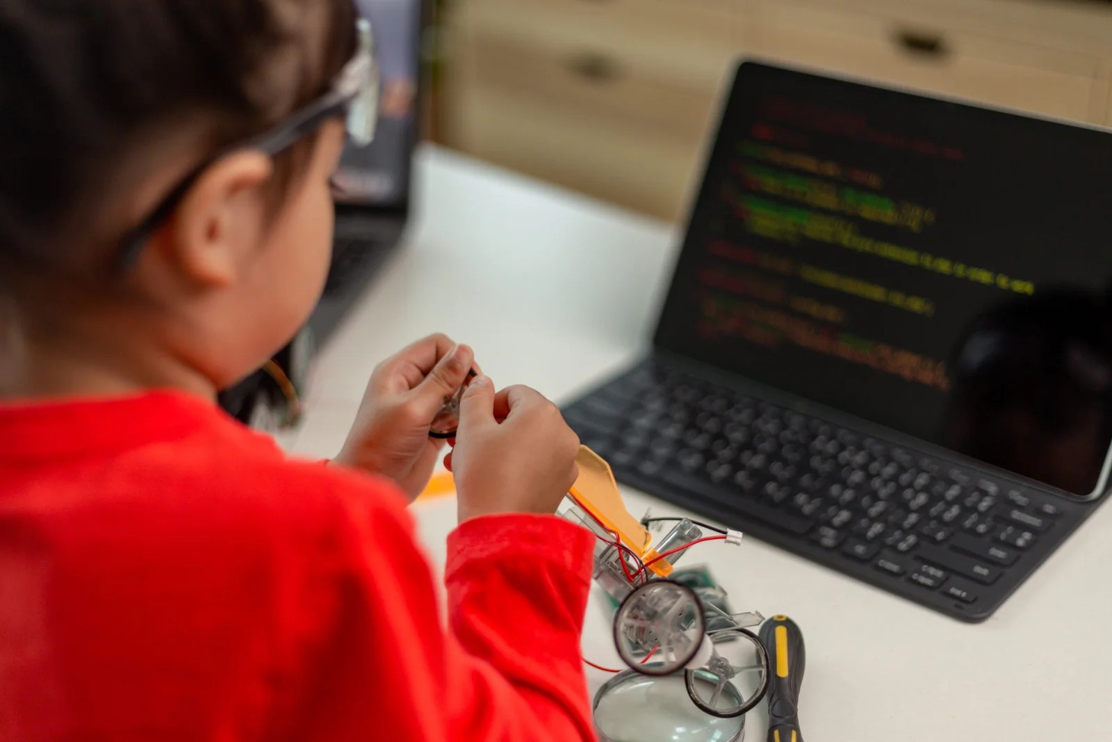 Child working on a robotics project with coding on a tablet screen in a STEM lab setting in Nagpur.
