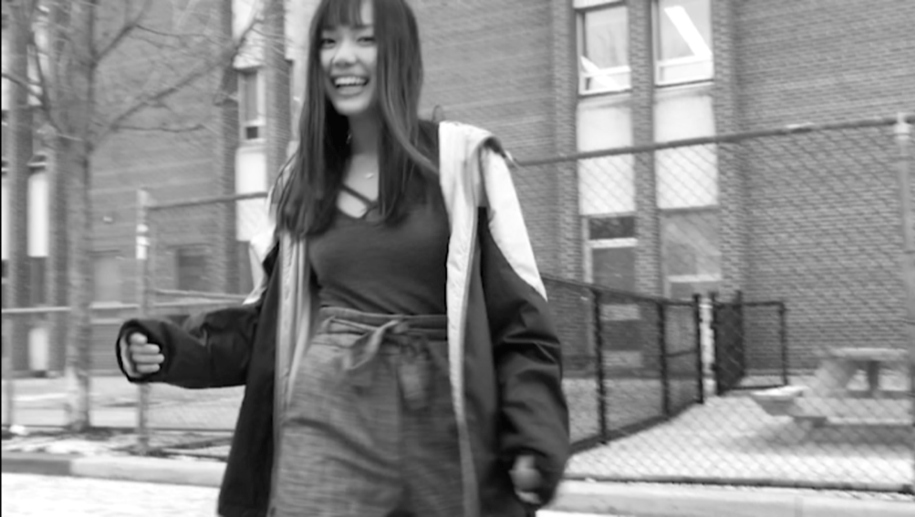 02: Girl giggling outside while dancing. Medium Long Shot & Low Angle (Bordwell and Thompson, 189).