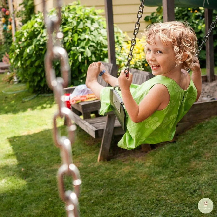 Child playing on a backyard swing during outdoor time, showing a natural part of a stay-at-home mom’s daily routine flow