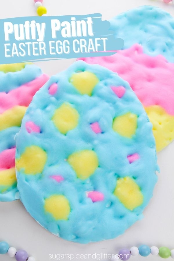 Colorful puffy paint Easter egg craft made with blue, pink, and yellow textured paint decorated with pastel dots.