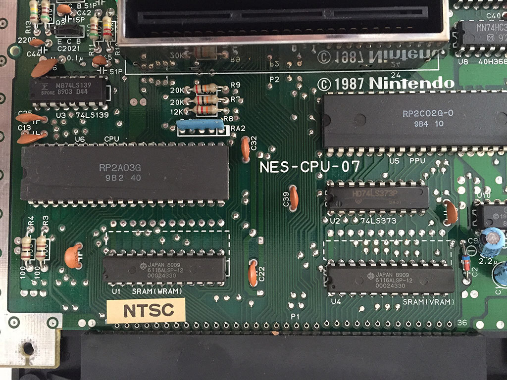 Here we take a close up at the circuit board, the two large chips are the Picture Prossesing Units or PPUs, note that this unit was manufactured in 1987. Right on top of the date you will see what they call the "Expansion Slot" which was apparently never used