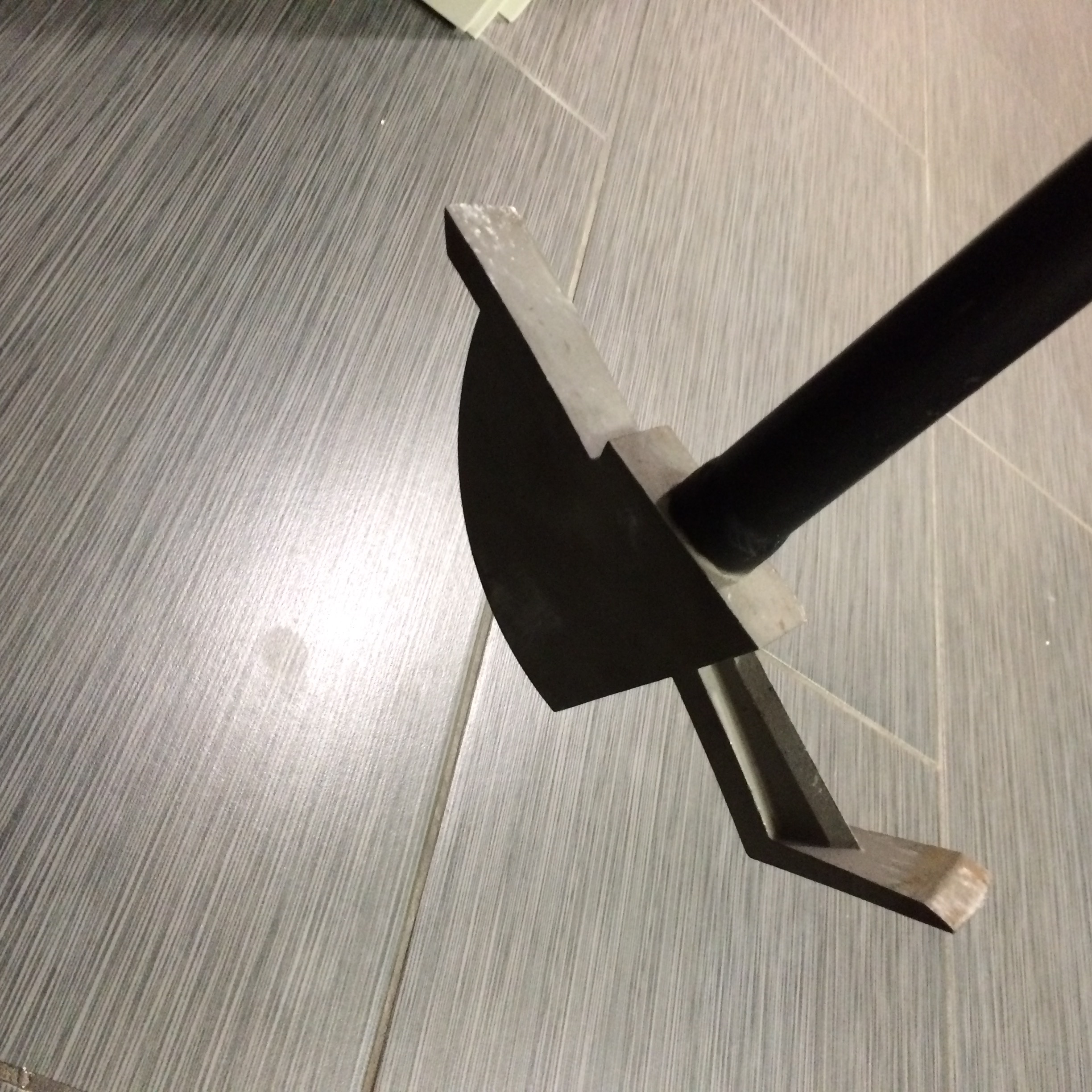For thicker and heavier finish materials, a series of strikes with the Hawk's wedge-like tip breaks things up, proving access points for peeling up whole sections or reducing materials to more easily moved or removed bits.