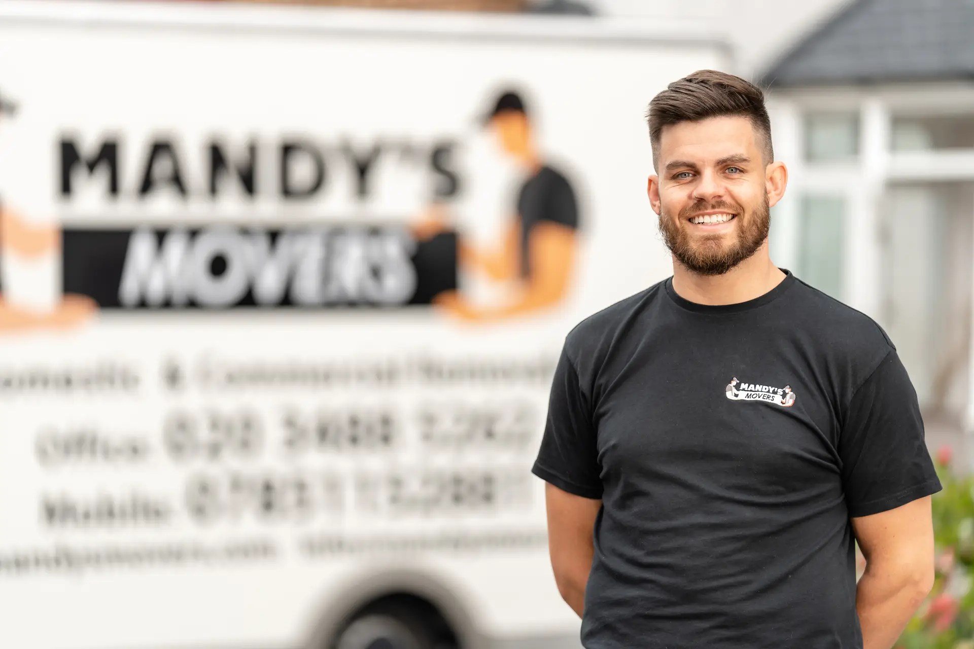 Ben from Mandy's Movers in front of a branded removal van