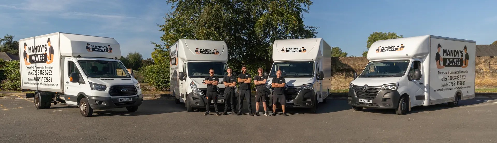 The Mandy's Movers team standing in front of four removal vans