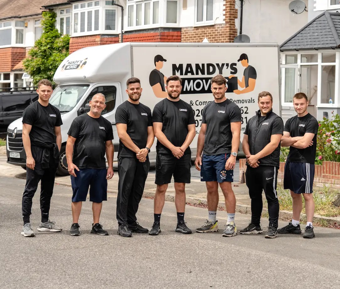 The Mandy's Movers team standing in front of a branded removal van