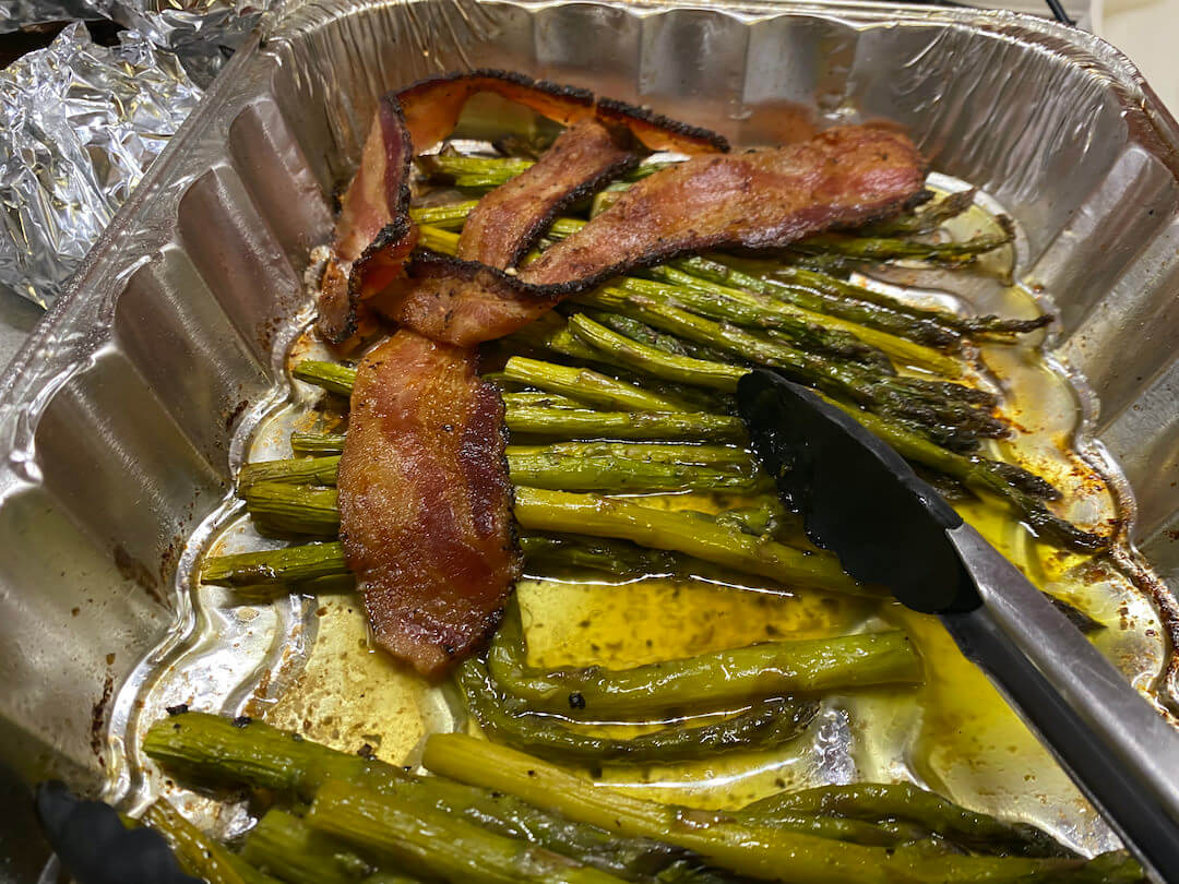 This photo shows bacon and asparagus cooked on a pellet smoker.