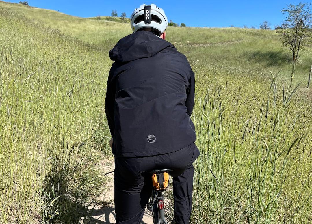 This photos shows the back view of the Showers Pass Timberline rain jacket.