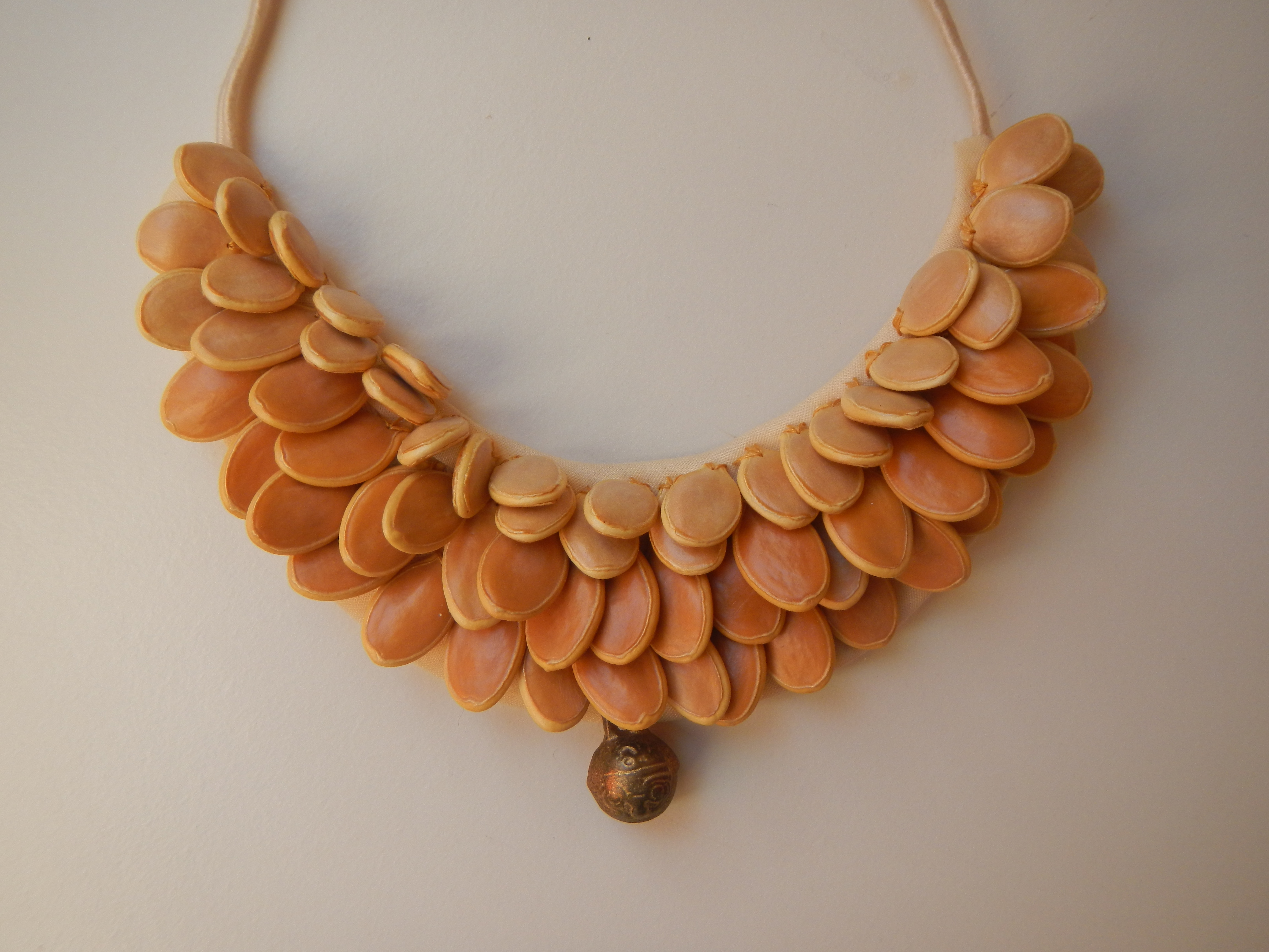 SOLD pumpkin seeds and chinese pendant ~ collo di semi di zucca cuciti su tessuto e ciondolo cinese