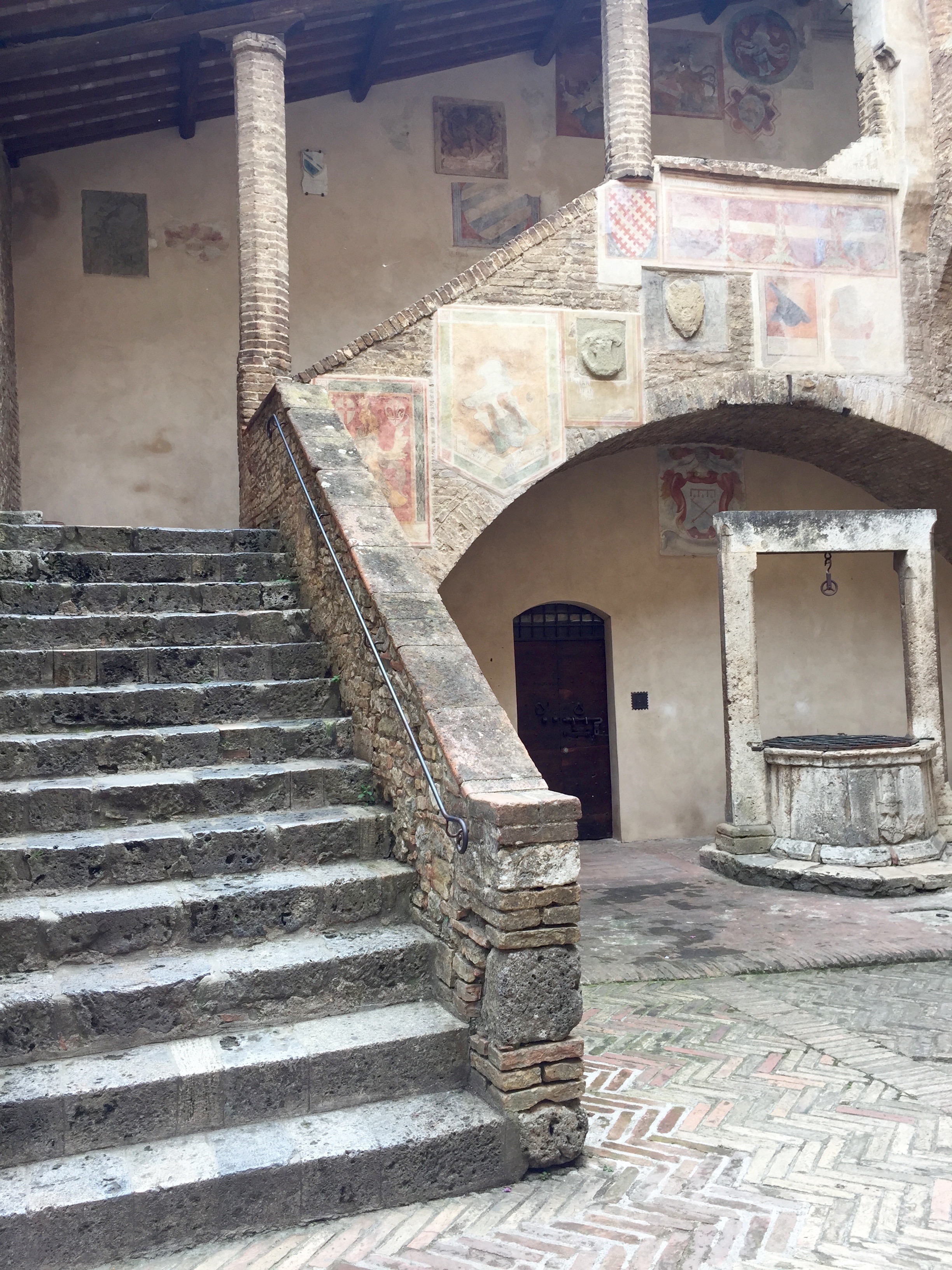 You can see the different frescos, all weathered and aged above the water well along the staircase