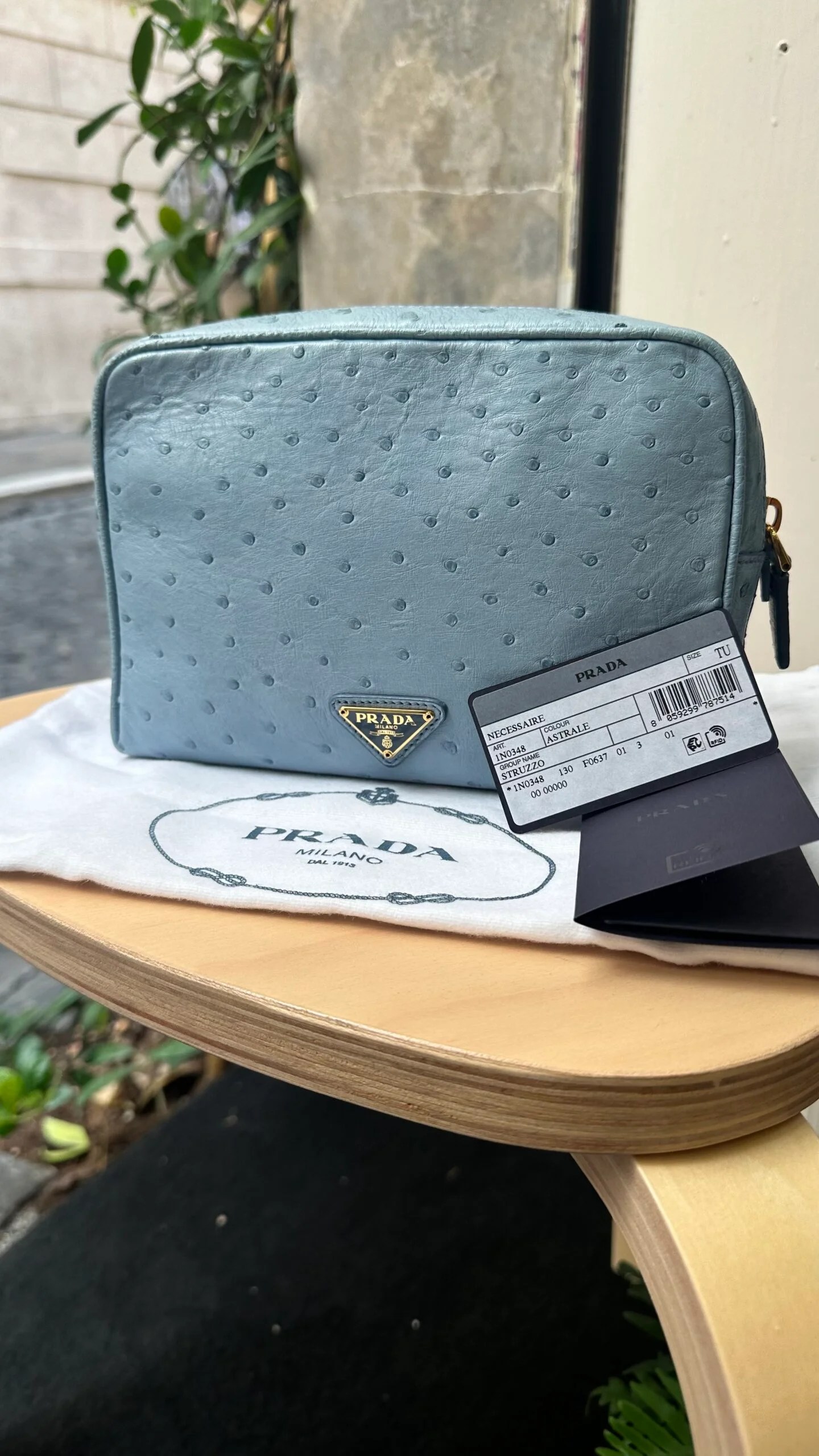PRADA Pochette necessaire Prada in pelle di struzzo color astrale — DelixGo Luxury Bags