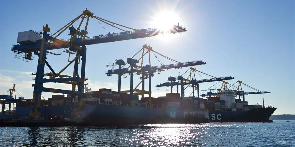 Cargo ships loading and unloading at a busy port.