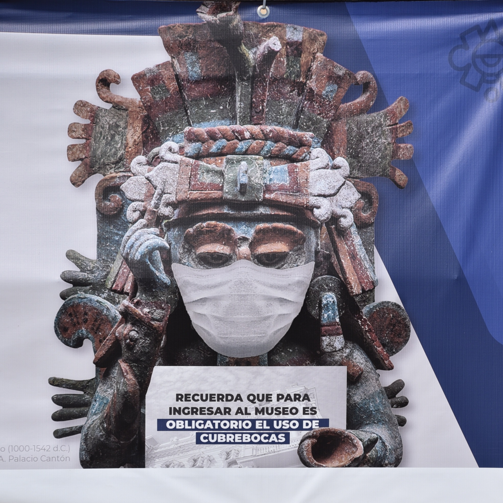 mayan stature wearing a mask as required while traveling in Merida Mexico