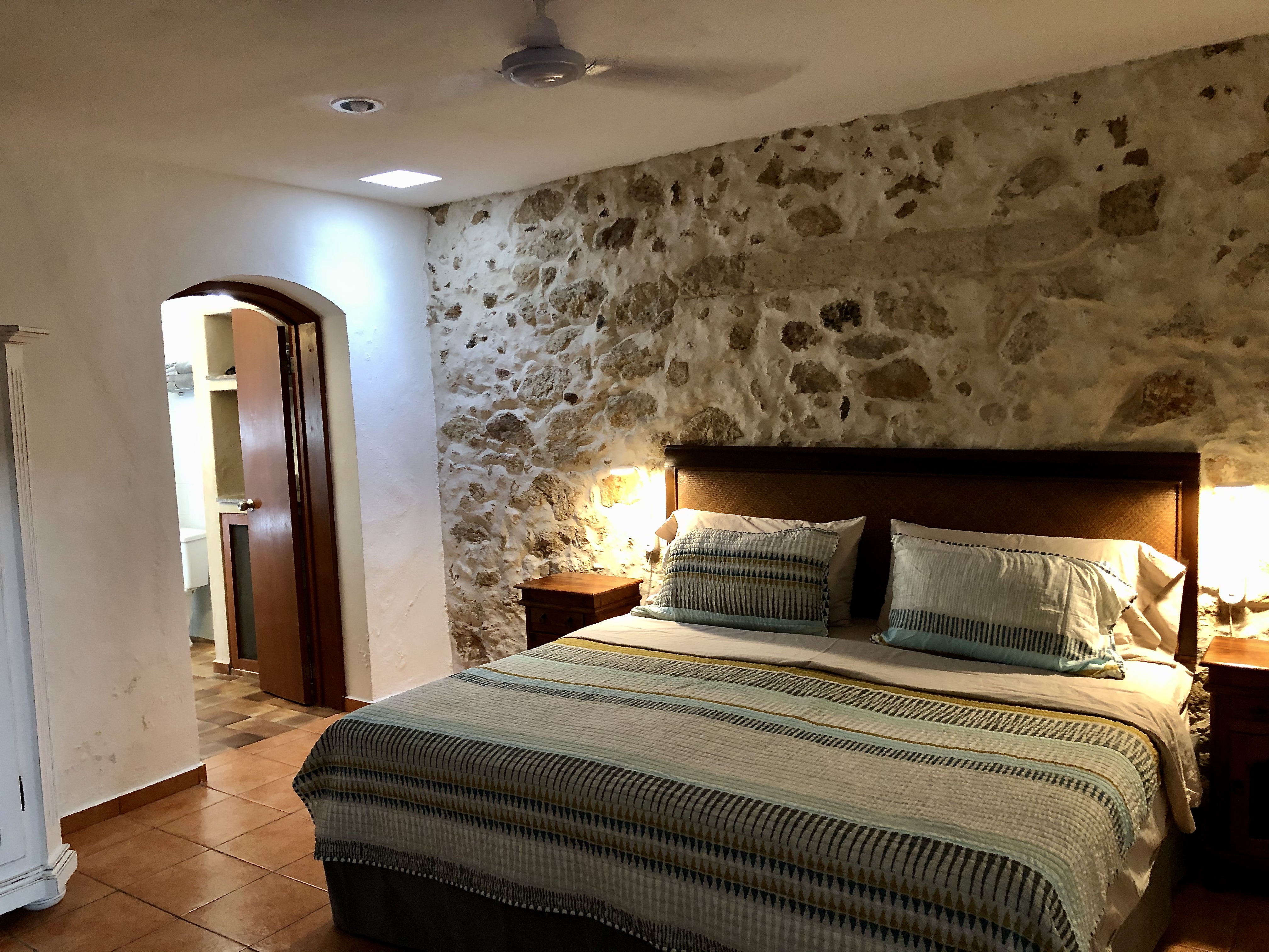 bedroom of with rustic wall and huge bathroom