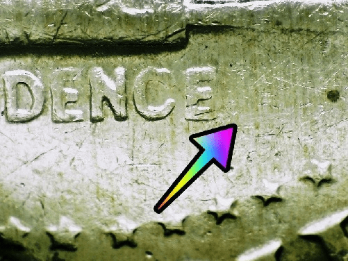 microscopic image of bicentennial half dollar errors noted with arrows on a 1976 half dollar coin