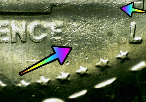 microscopic image with arrows noting errors on a bicentennial Kennedy half dollar