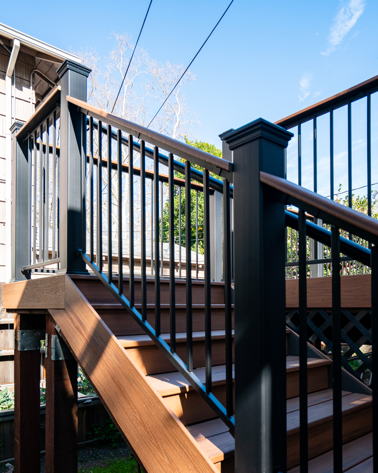 Elevated backyard deck with metal railing, built by Marksman Builders in Sacramento, CA