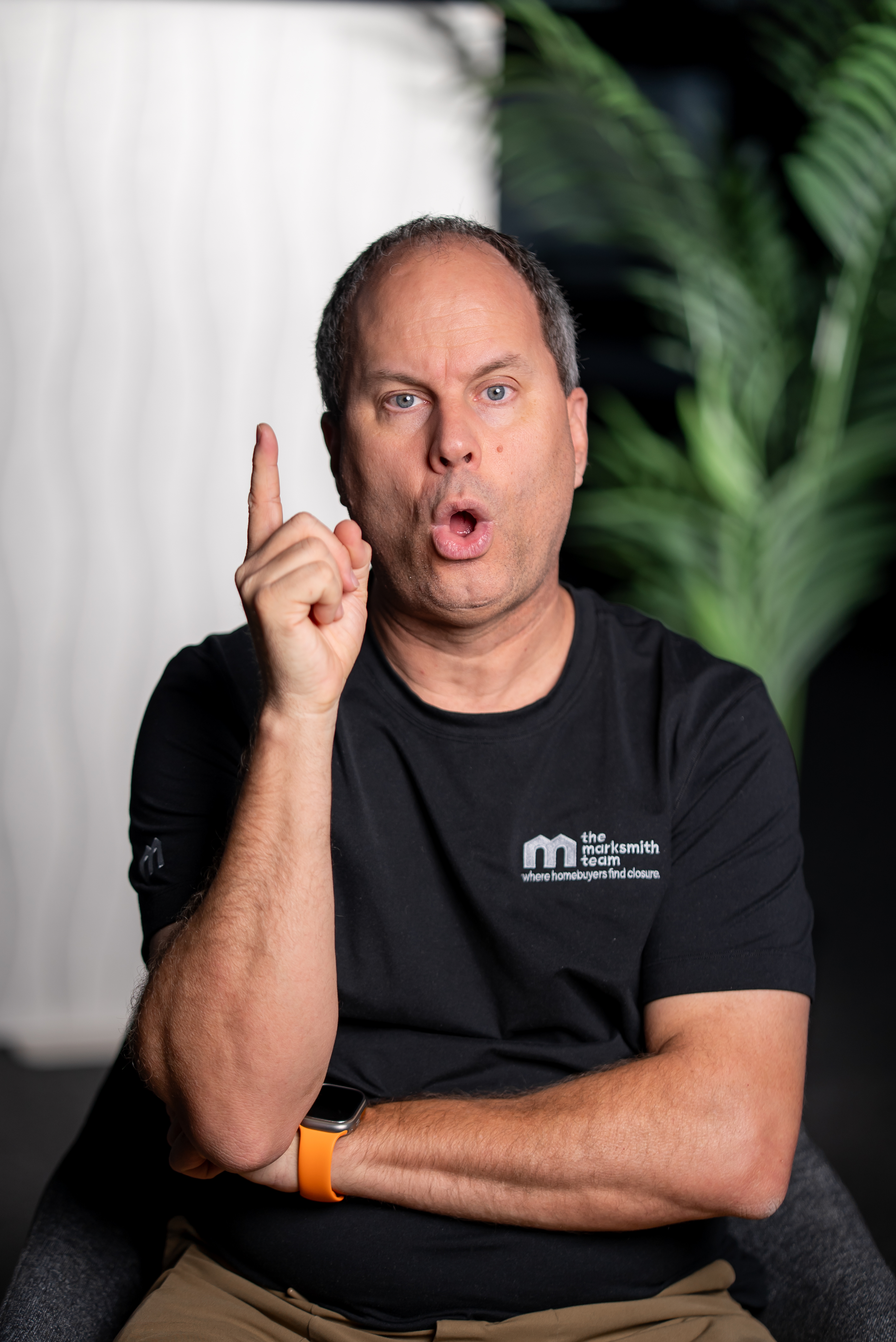 Mark Smith raising one finger as if making an important point.