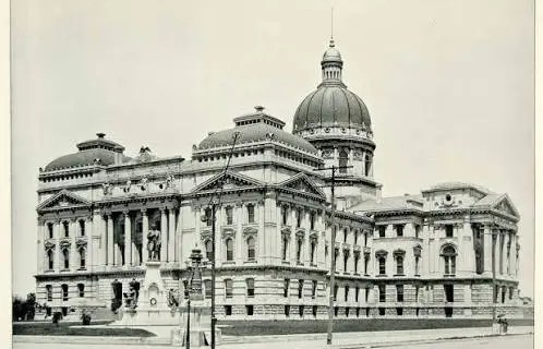 Historic domed government building with neoclassical columns, photographed from the street (black-and-white).