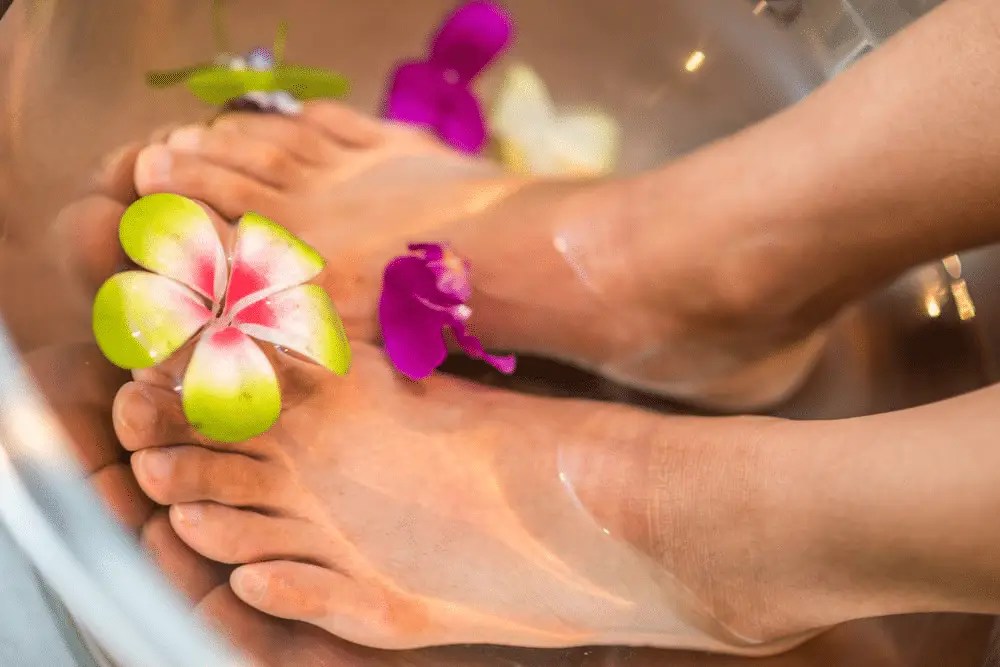 A woman soaking her feet before a custom massage in Minneapolis