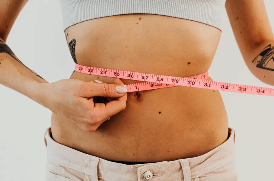 A woman after getting non-invasive body contouring.