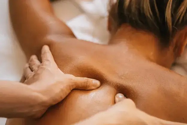 close-up of a client getting a back massage from a masseuse