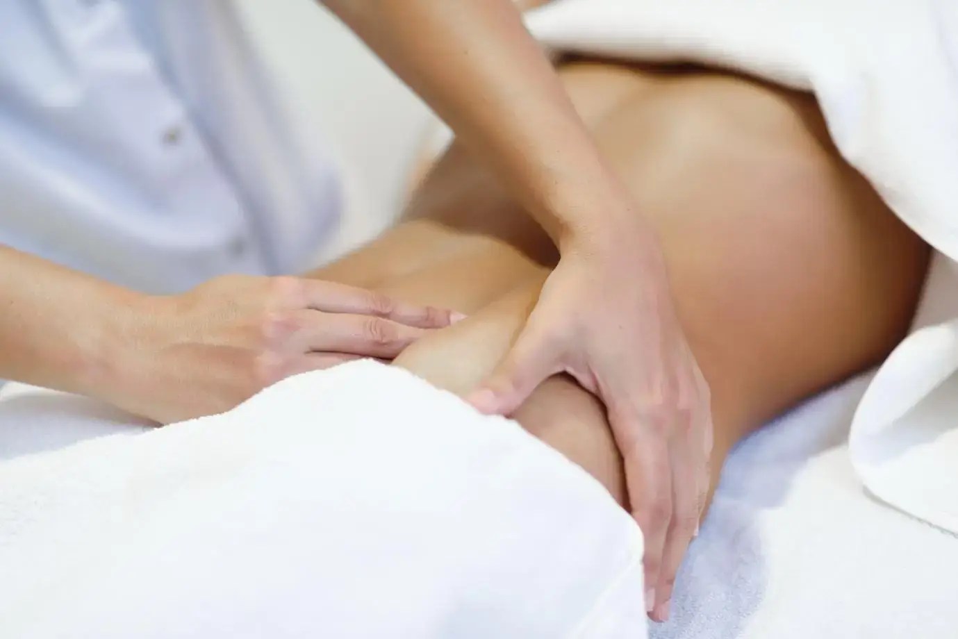 Massage therapist performing fascia release on a client’s back