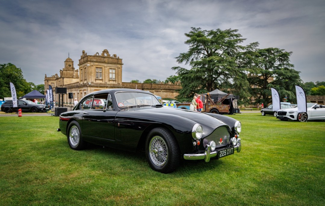 A concours-prepared classic sports car displayed in front of Longleat House