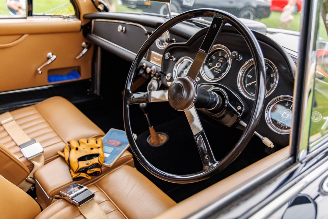 Leather driving gloves and a motoring event programme inside a carefully preserved classic car