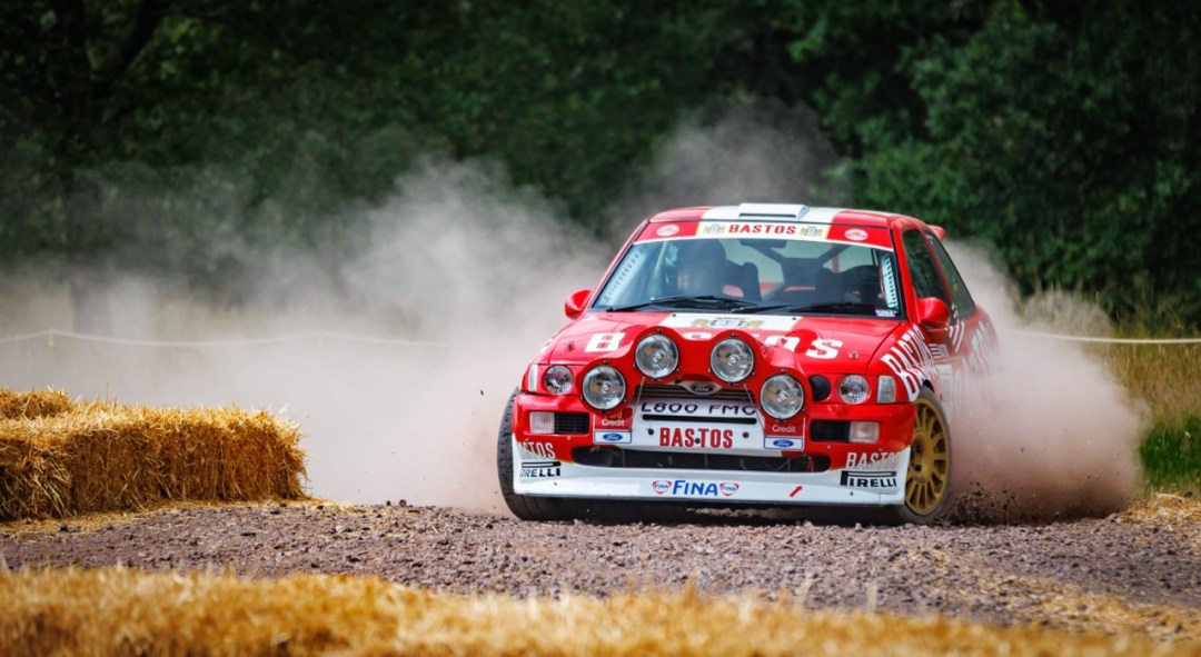 Historic red rally car in action on the Longleat live demonstration course