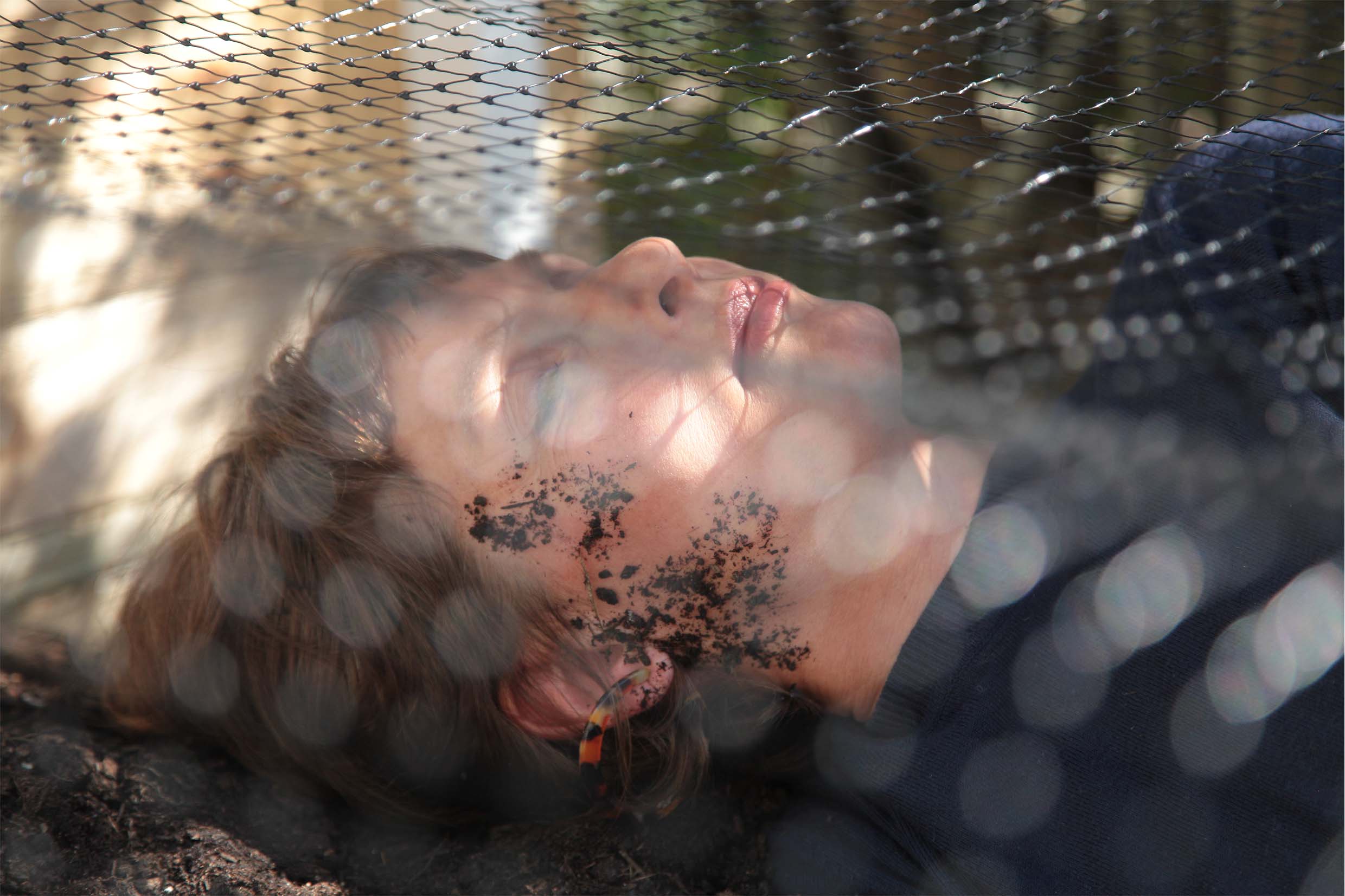Miranda Whall laying under a net