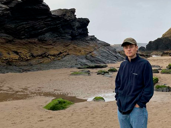 Twm Ebbsworth standing on a beach