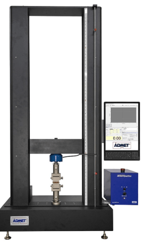 The image shows a universal testing machine testing a sandwich composite panel with bonded face sheets and lightweight core material according to ASTM C297 in flatwise tensile mode.