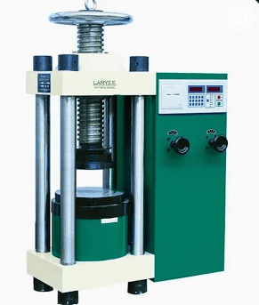 The image shows a compression testing machine that applies compressive force until specimen failure occurs during ASTM C109 testing.