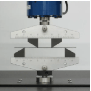 The image shows that the bend testing fixture evaluates the bending performance and ductility of steel strips during ASTM A109 testing.