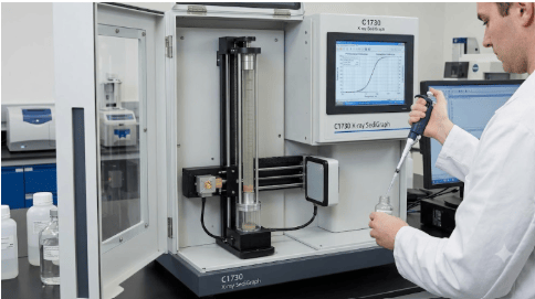 The image shows an X-ray gravity sedimentation particle size analyzer determining the particle size distribution of advanced ceramic powders according to ASTM C1730.
