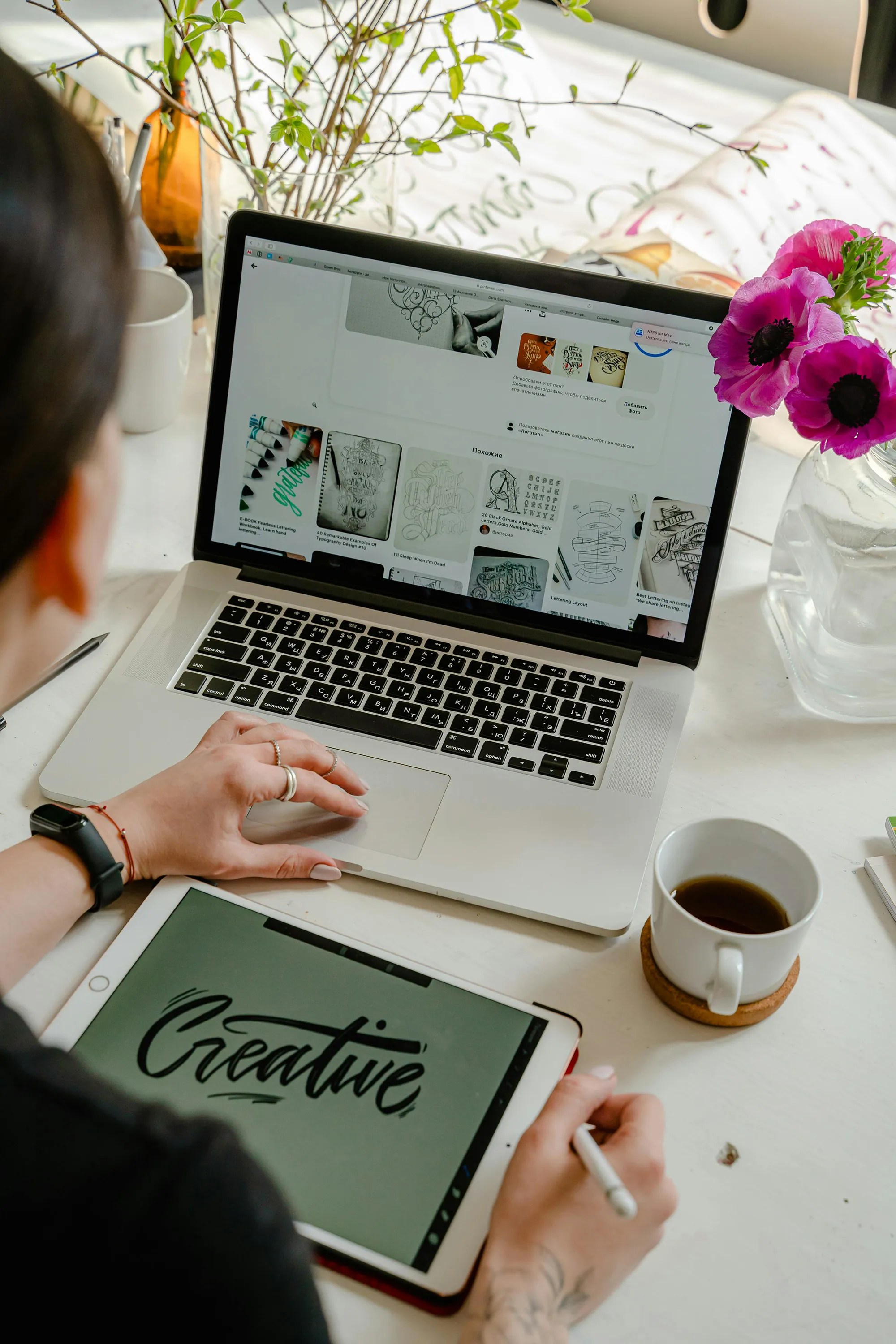Designer woman in front of a laptop designing a logo using a stylus pen