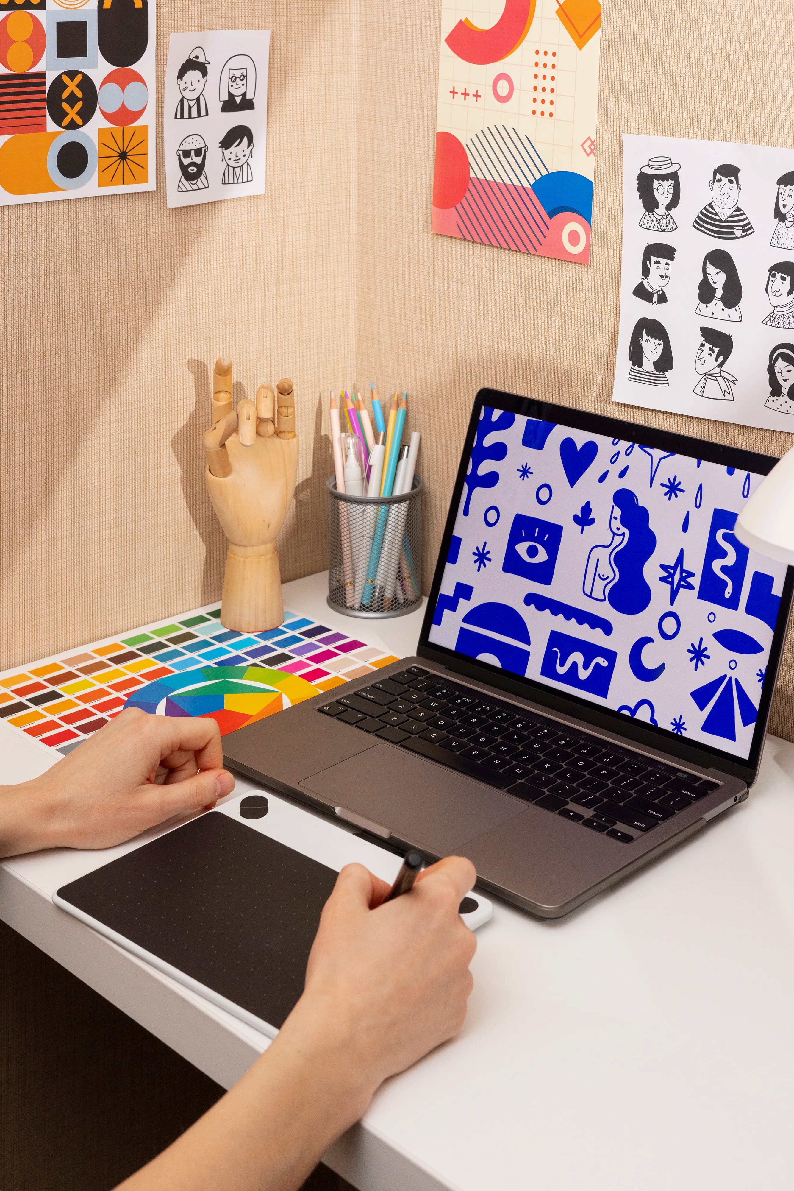 Designer in front of a laptop using stylus pen
