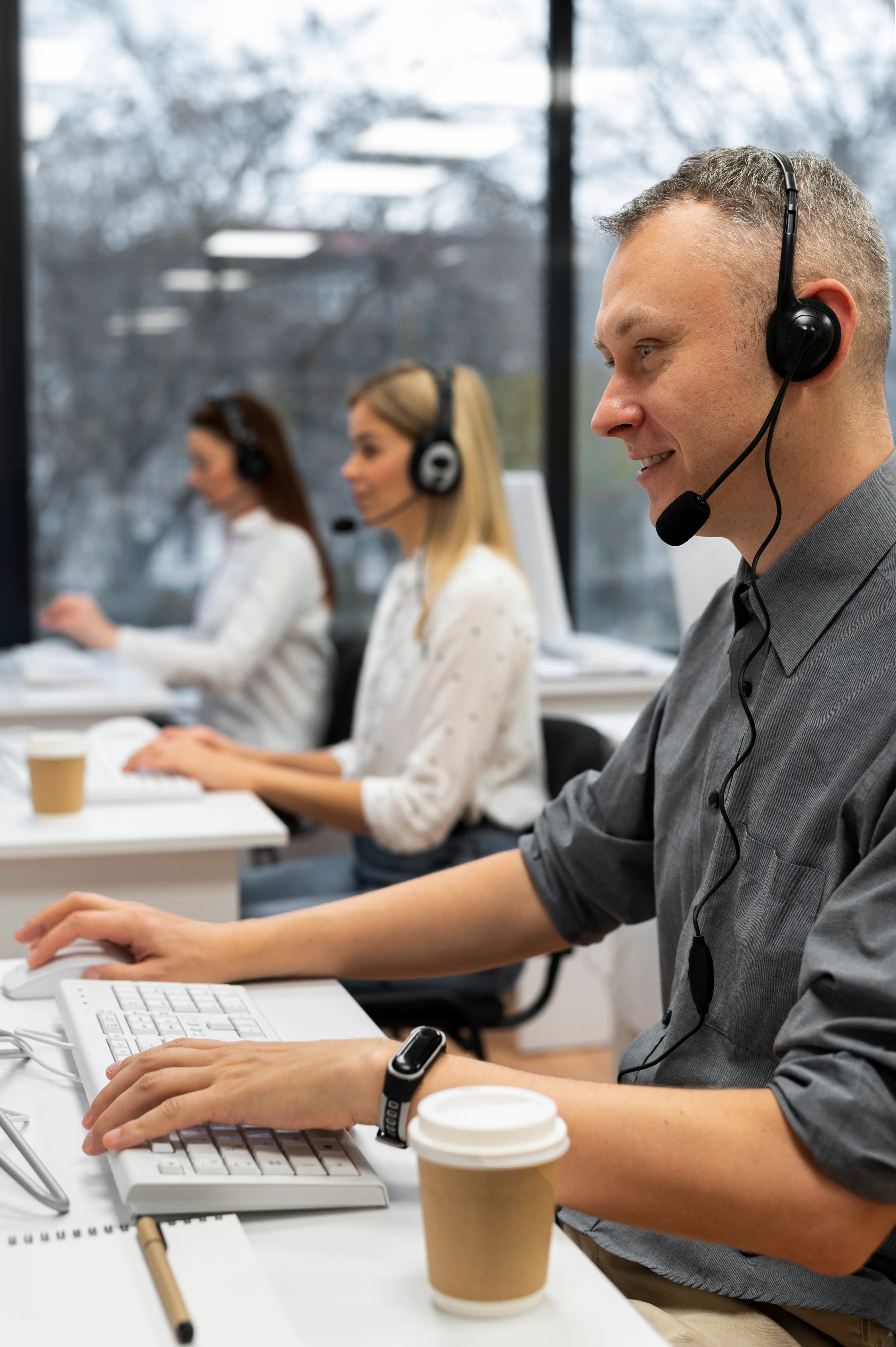 colleagues working together at a call center office with coffee