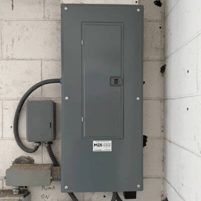 Electrical Panel with white cinderblock background